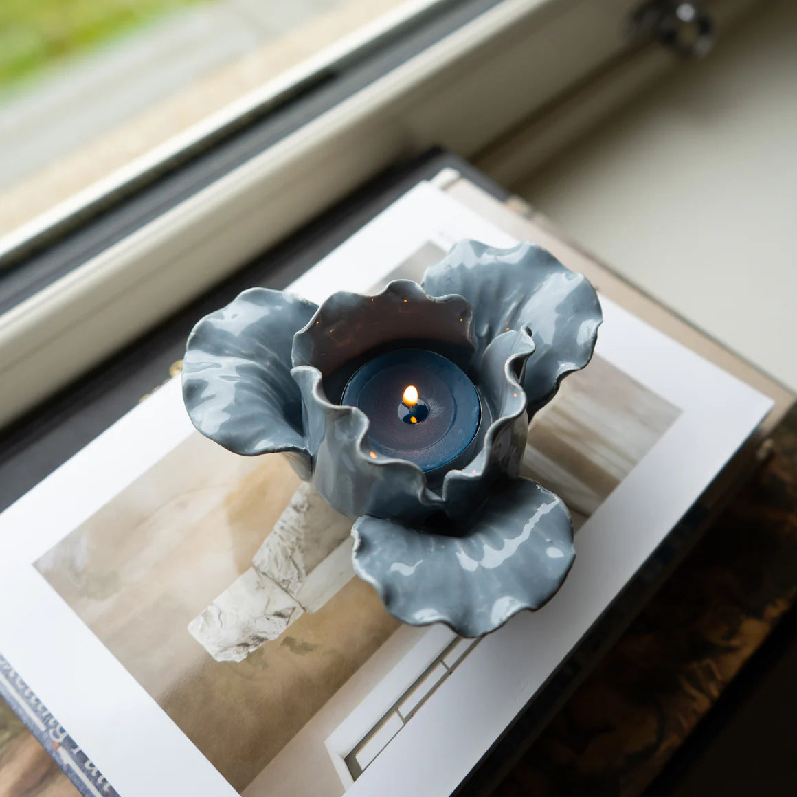 A serene setting featuring the Flower Shaped Tealight Holder - Blue, perfect for those looking for a stunning flower tealight holder.