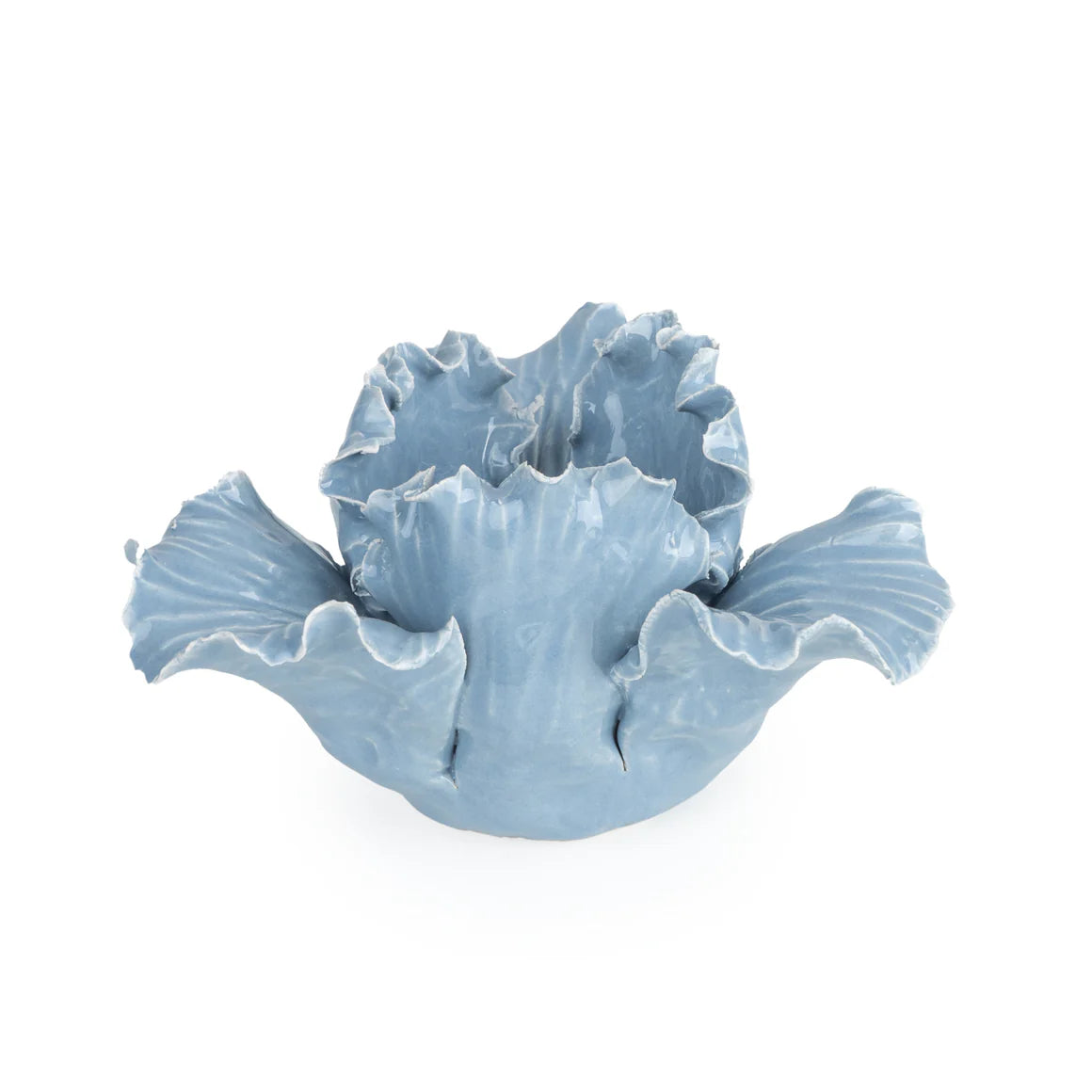 The Flower Shaped Tealight Holder - Blue displayed in a garden setting, reflecting the beauty of this flower tealight holder.