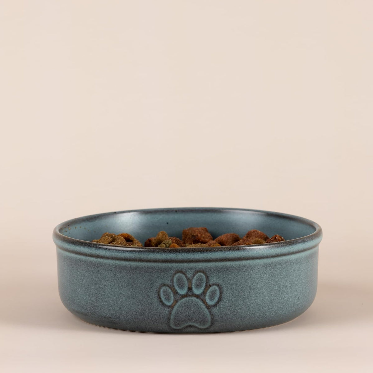 Mason Cash Reactive Paw Large Dog Bowl shown filled with water, demonstrating its 950ml capacity and practical use as a stoneware pet bowl.
