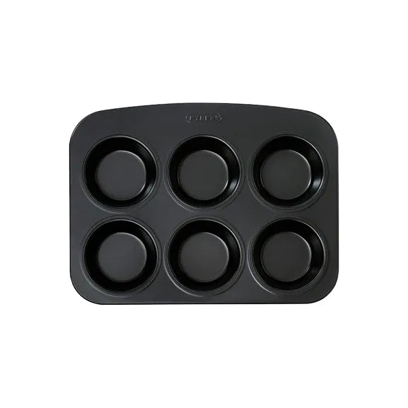 Lifestyle image of the Pyrex Glide 6 Muffin and Cupcake Tray filled with freshly baked muffins and cupcakes.