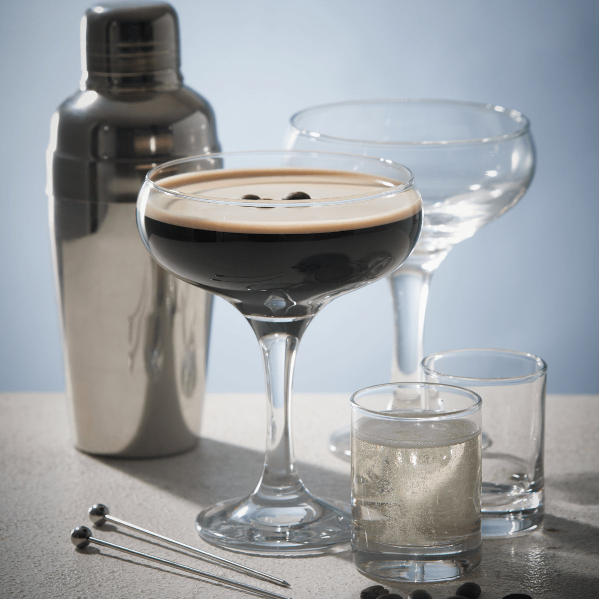 Ravenhead Entertain Set 2 Cocktail Saucer Glasses 20cl set against a stylish backdrop highlighting the coupe cocktail glasses.
