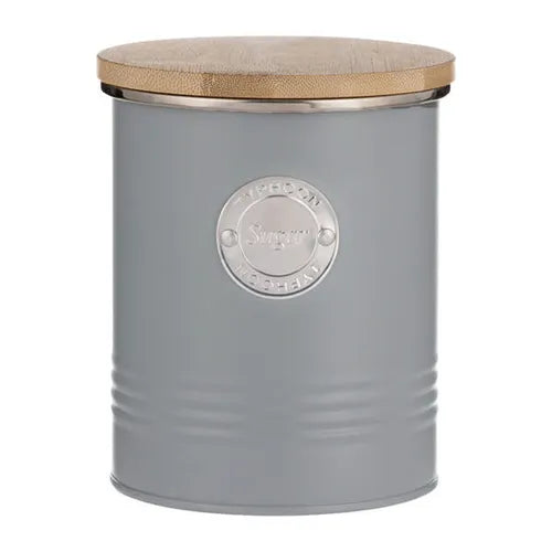 Close-up of Typhoon Living metal kitchen canister set showcasing the vintage grey finish and embossed medallion detail.