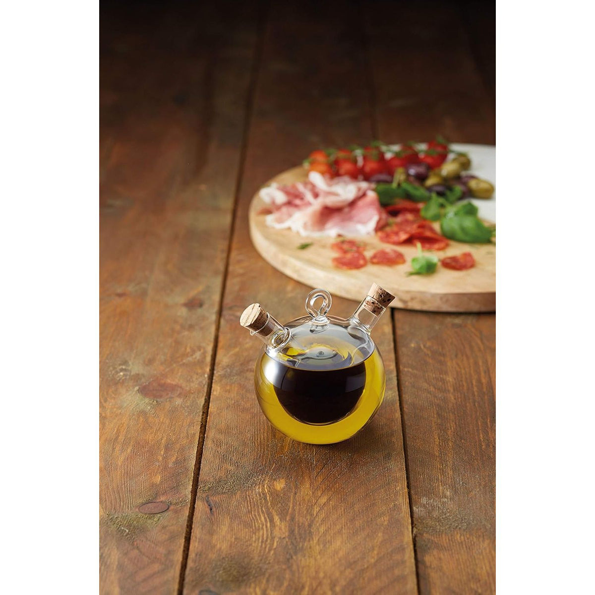 Close-up view of the World of Flavours 2-in-1 Round Olive Oil Dispenser showcasing the dual spouts and cork stoppers, ideal for dispensing olive oil with ease.