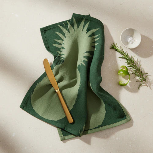 Close-up view of printed tea towels featuring a pineapple design, part of the set of two, perfect for kitchen use.