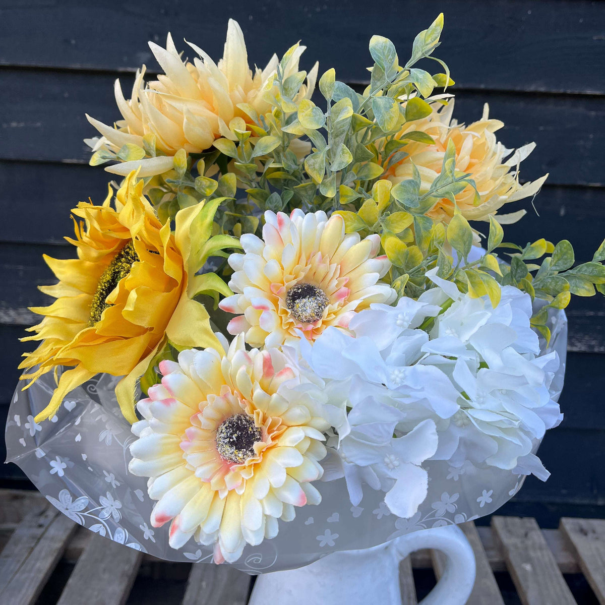 Cheerful sunflower and gerbera bouquet featuring vibrant artificial flowers in summery colours of white, yellow, and red.