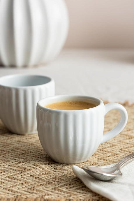 Stylish collection of Price & Kensington stoneware tea mugs in white, green, and quirky designs, part of our Cups & Mugs selection.