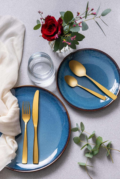 Mason Cash Reactive Blue stoneware dinner set displayed on a table, emphasizing its durability and stylish design for everyday meals.