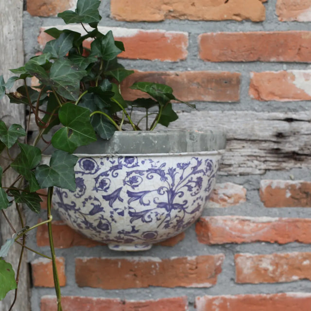 Aged ceramic wall planter showcasing its elegant design, perfect for adding greenery to any wall.