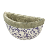 Side view of the ceramic wall planter highlighting the two mounting holes for easy installation.