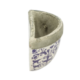 View from above of the aged ceramic wall planter, illustrating its bowl-like design for holding plants.