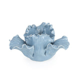 The Flower Shaped Tealight Holder - Blue displayed in a garden setting, reflecting the beauty of this flower tealight holder.