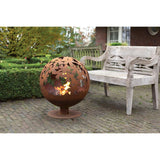 Rust fire ball design with laser cut leaves glowing in the light; an attractive laser cut fire pit for evening warmth.
