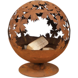 Wide view of the rust fire ball laser cut fire pit surrounded by stones; perfect for creating a warm atmosphere.