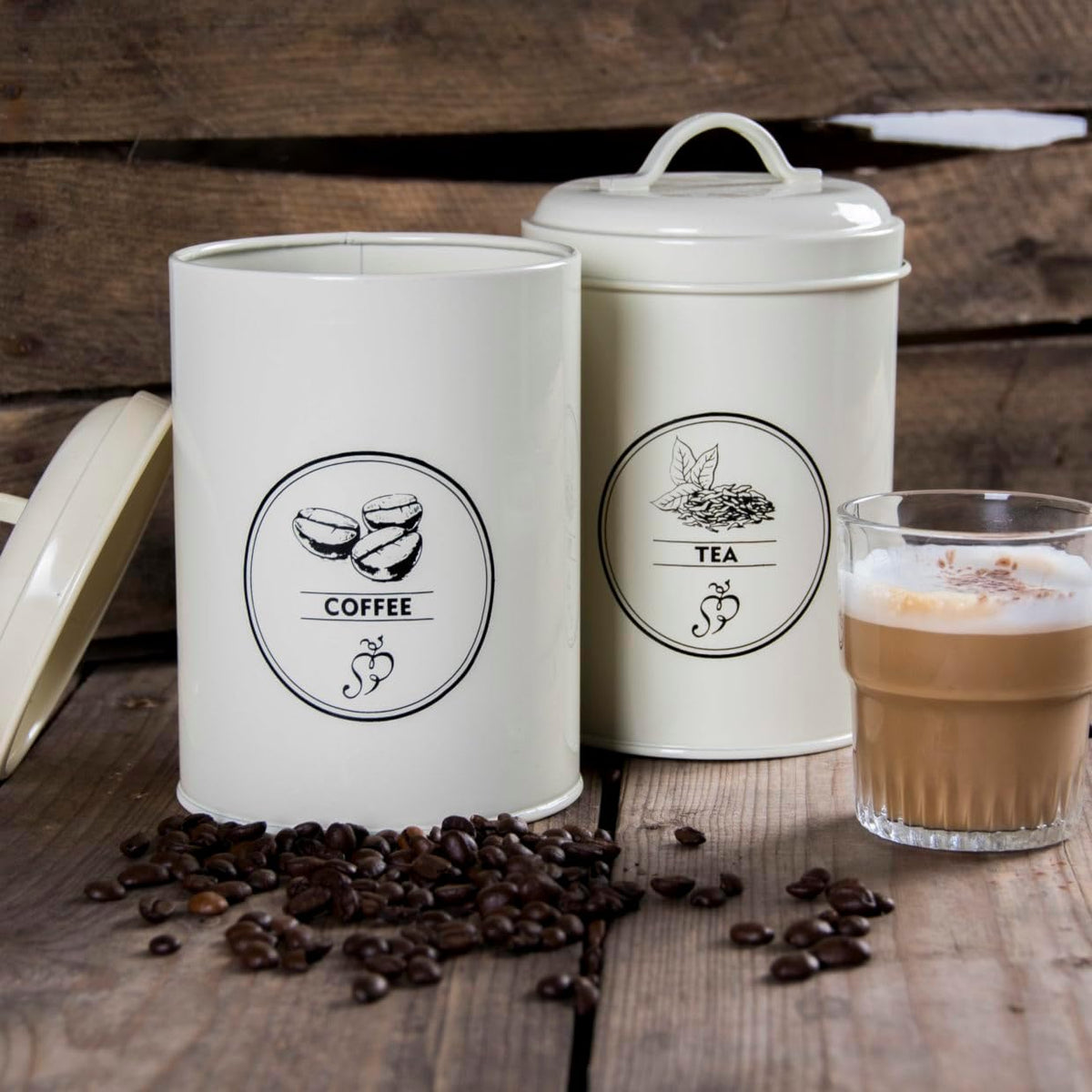 Minimalist farmhouse kitchen storage canisters set, featuring stylish graphics for tea, coffee, and sugar.