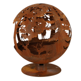Outdoor scene featuring the fire ball laser cut rust woodland laser cut fire pit in use during a gathering.