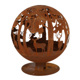 The fire ball laser cut rust woodland laser cut fire pit set against a rustic backdrop, ideal for gatherings.