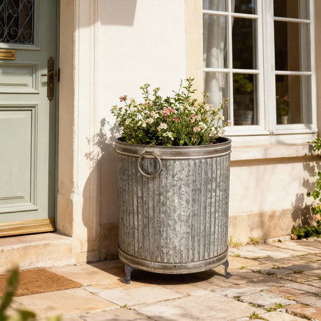 Set of 3 round footed zinc planters showcased with a decorative ribbed surface and strong cast iron legs, perfect for enhancing garden spaces, ideal for flowers and herbs as stylish zinc footed planters.