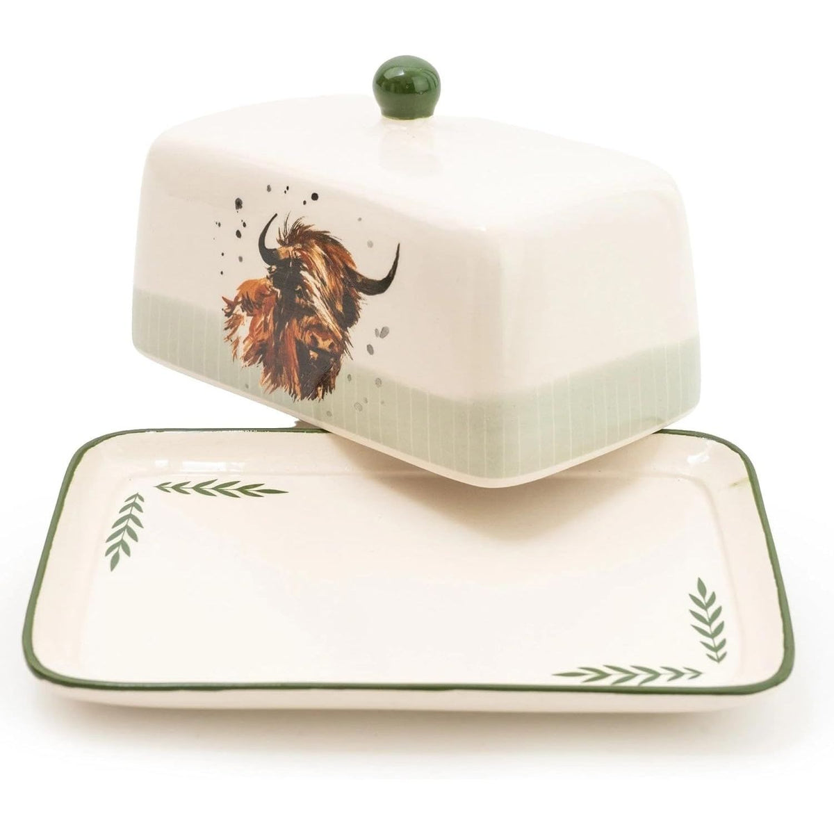 Ceramic butter dish with lid featuring a cow design on a white background
