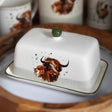 Butter dish with a cow design on a wooden surface