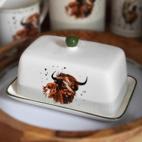 Butter dish with a cow design on a wooden surface