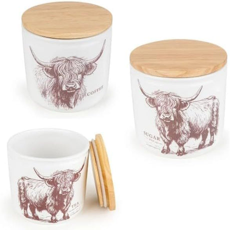 Set of Highland Cow Ceramic Kitchen Containers - White canisters with bamboo lids, designed for keeping tea, coffee, and sugar organized.