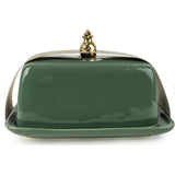 Green ceramic butter dish with a gold knob on a white background