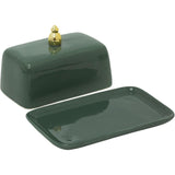 Green ceramic butter dish with a lid on a white background