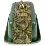 Green butter dish with decorative label and gold accents on a white background