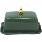 Green ceramic butter dish with a gold lid on a white background