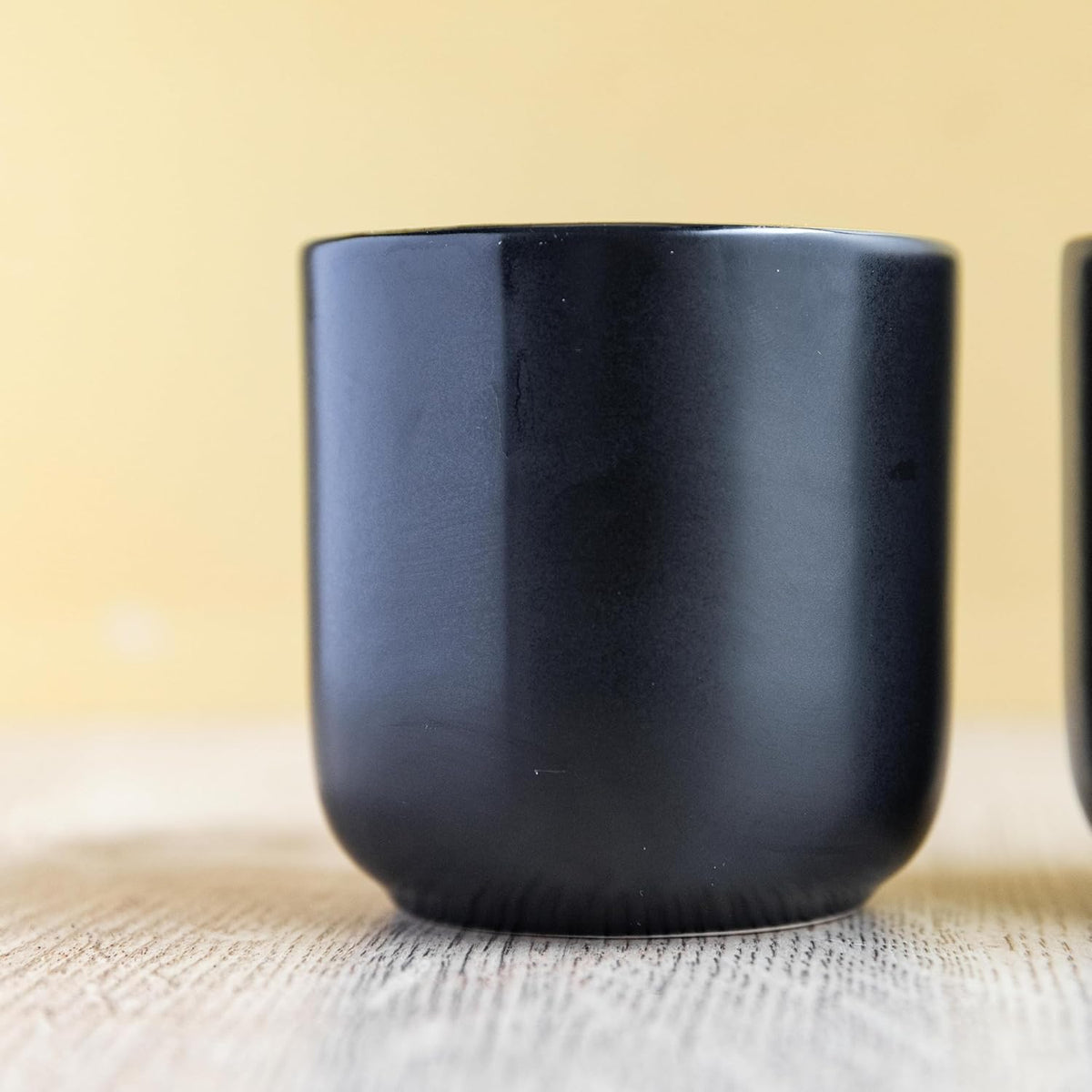 Close-up of La Cafetière Double Walled Espresso Mugs showcasing the sleek matte black exterior and exquisite gold lining.