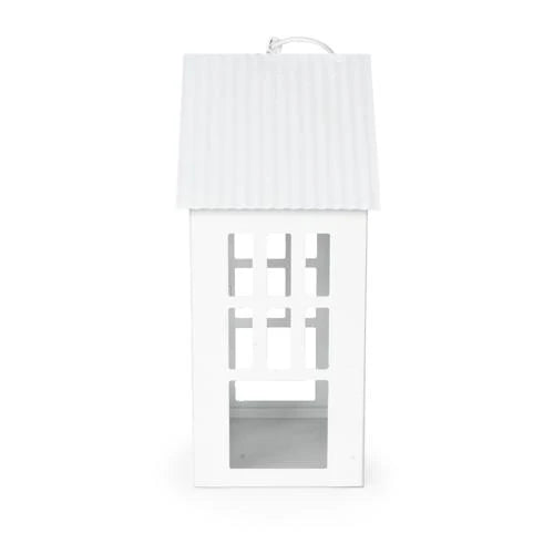 24cm Town House Lantern in White displayed with a candle inside, illustrating a decorative metal lantern's warm glow and charming appeal.