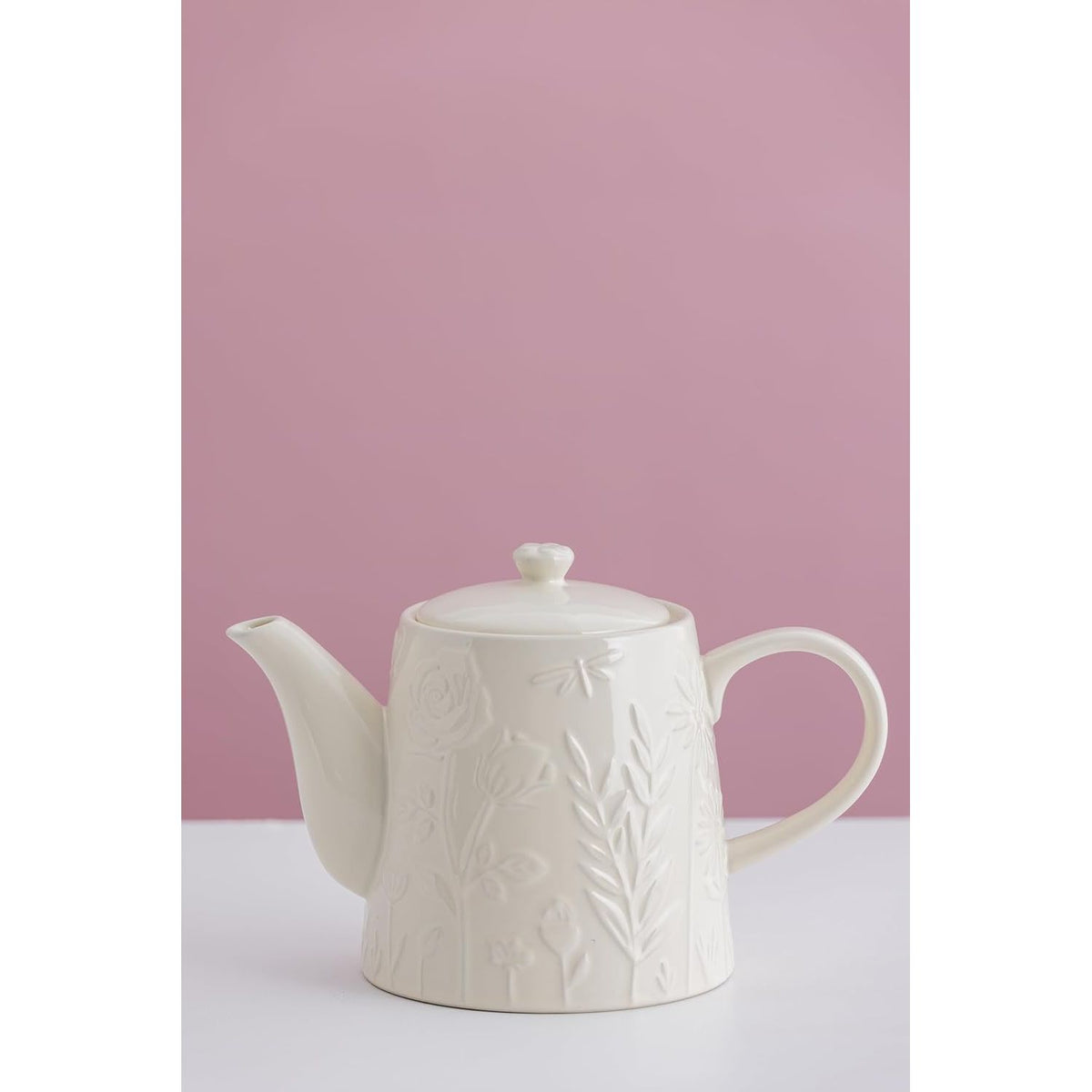 Side view of the Mason Cash in The Meadow Teapot 800ml with a soft pink background, showcasing its durable stoneware design and floral embossing.