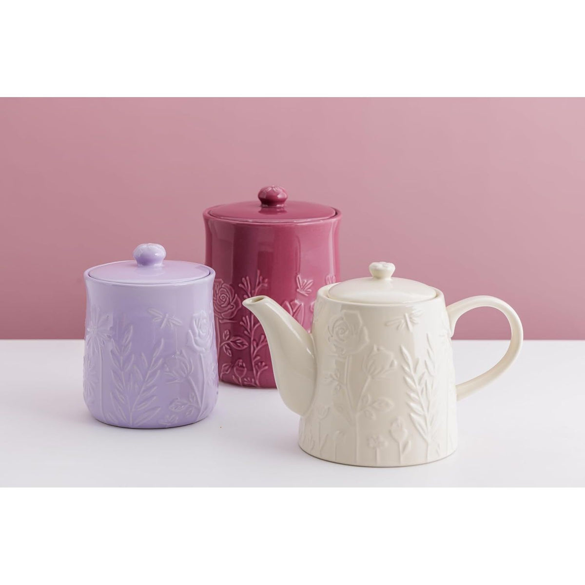 Mason Cash in The Meadow Teapot 800ml alongside complementary storage jars, highlighting its stylish durable stoneware teapot with a charming floral pattern.