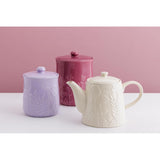 Mason Cash in The Meadow Teapot 800ml alongside complementary storage jars, highlighting its stylish durable stoneware teapot with a charming floral pattern.