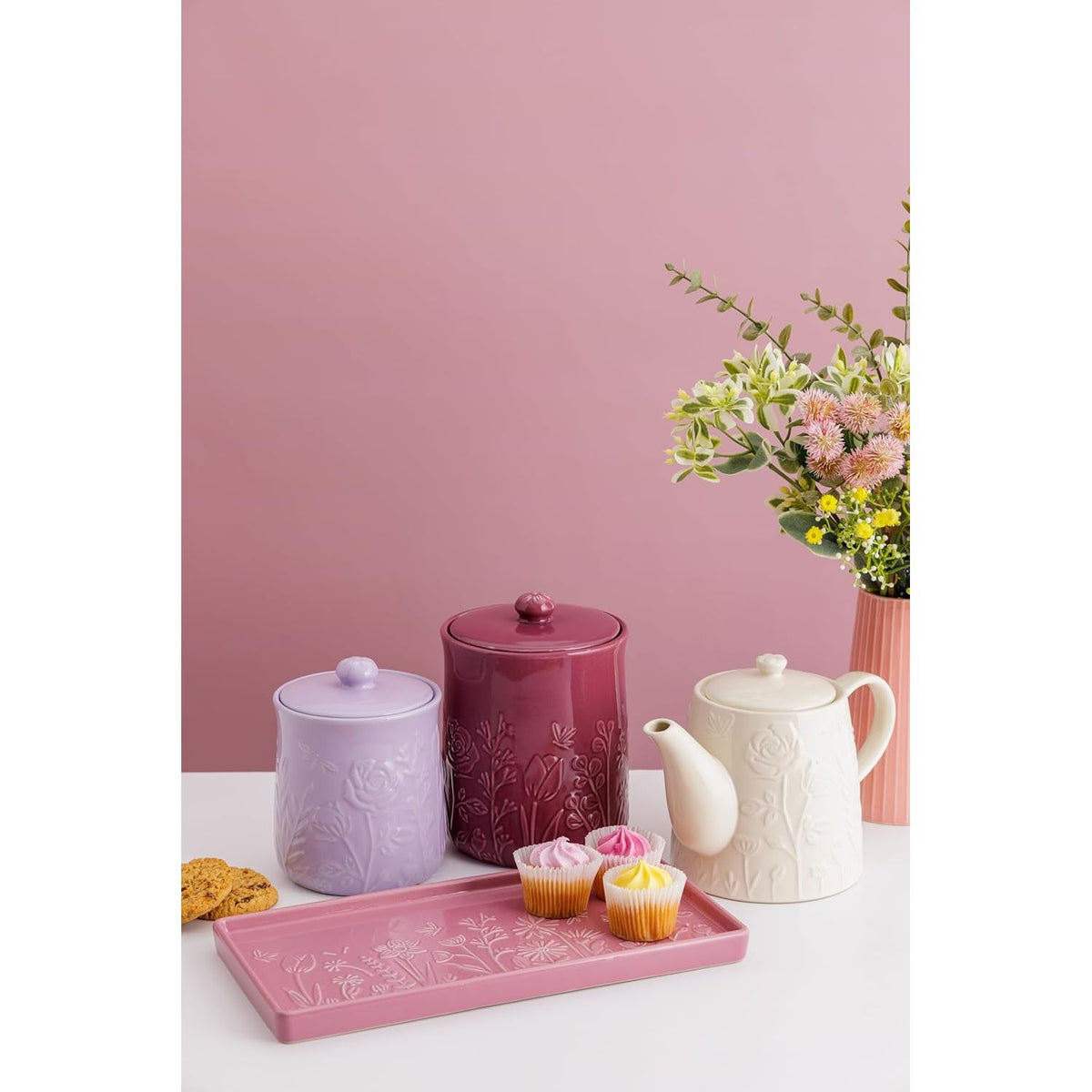 Mason Cash in The Meadow Teapot 800ml paired with treats and a bouquet, demonstrating its use as a durable stoneware teapot for delightful gatherings.