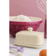 Mason Cash Meadow butter dish with Lid cream  with mixing bowl in the back and a pink wall 