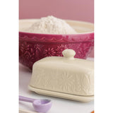 Mason Cash Meadow butter dish with Lid cream  with mixing bowl in the back and a pink wall upclose
