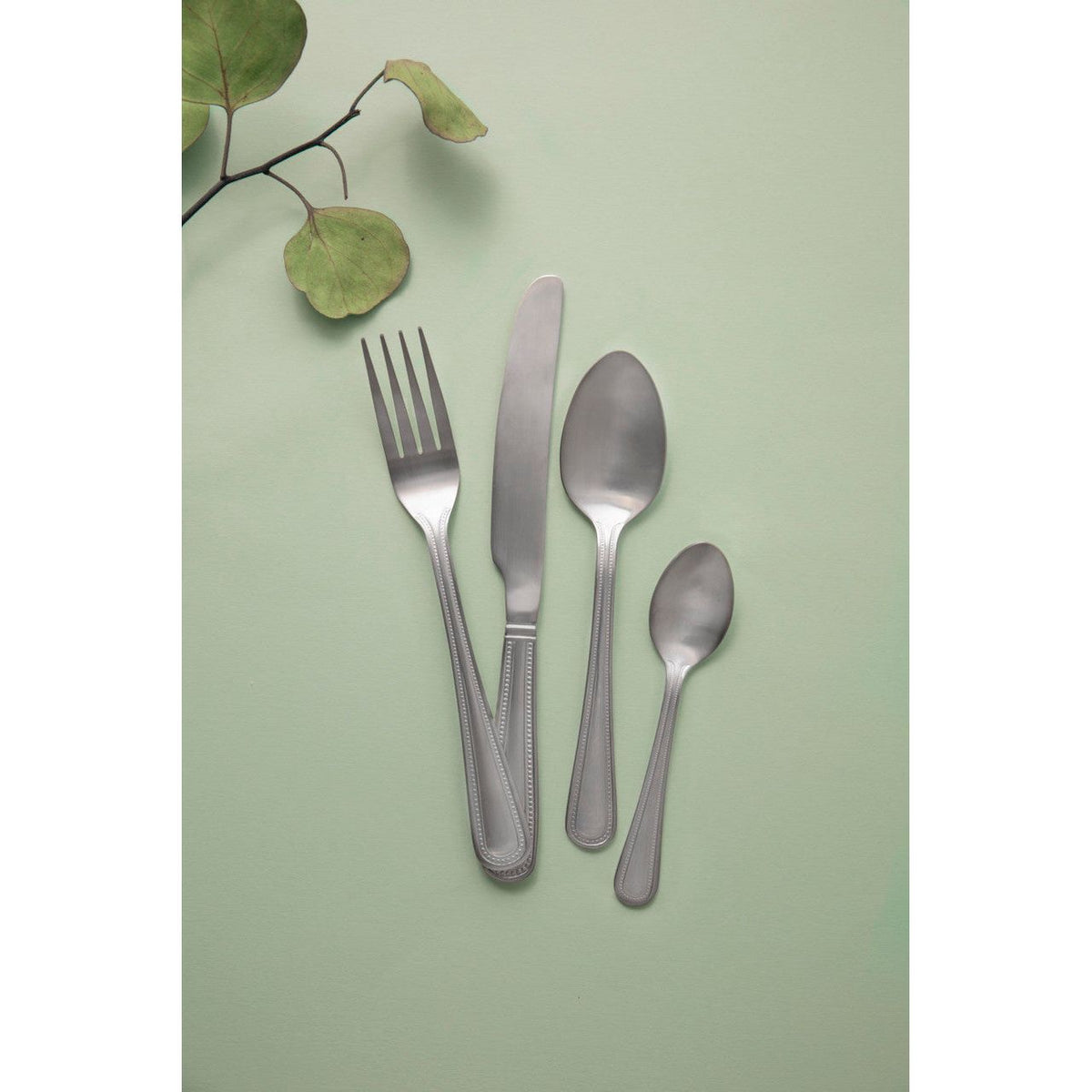 Mikasa Portobello Stainless Steel Cutlery Set, 16 Piece on a dining table showing versatility for both casual and formal gatherings.