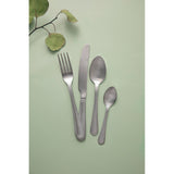 Mikasa Portobello Stainless Steel Cutlery Set, 16 Piece on a dining table showing versatility for both casual and formal gatherings.