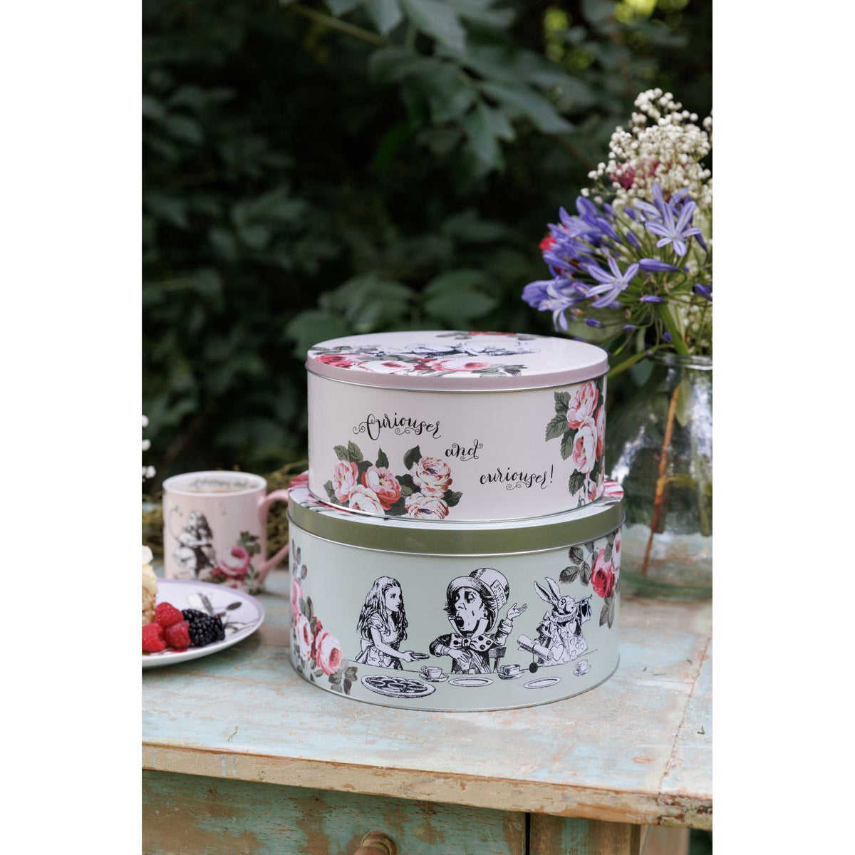 The smaller Mikasa Alice In Wonderland Cake Tin, highlighting its compact size for cupcakes and pastries.
