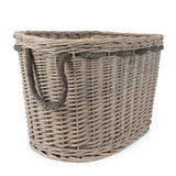 Luxurious oval log basket showcasing intricate design, great for a cozy fireplace setting.