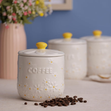 Close-up of the Price & Kensington Daisy Coffee Storage Jar showing the hand-painted yellow handle and ceramic finish, perfect airtight coffee storage jar.
