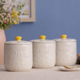 The airtight coffee storage jar from Price & Kensington featuring delicate daisy embossments and a cream glaze.