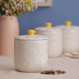 The whimsical Price & Kensington Daisy Sugar Storage Jar with a yellow hand-painted handle; perfect airtight ceramic canister for sugar storage.