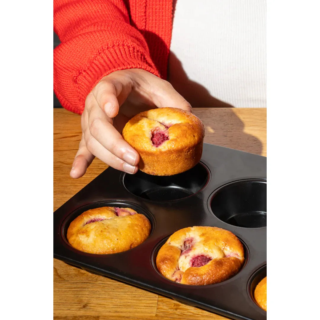 Close-up of the Pyrex Glide 6 Muffin and Cupcake Tray highlighting its scratch-resistant coating ideal for baking.