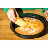 Pyrex Glide Cake tin 22cm shown with various baked goods, illustrating the versatility of this non-stick cake tin.