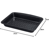 Versatile Pyrex Glide Metal Roaster 34x24cm displayed with roasted vegetables, the ideal non-stick roasting pan for any kitchen.