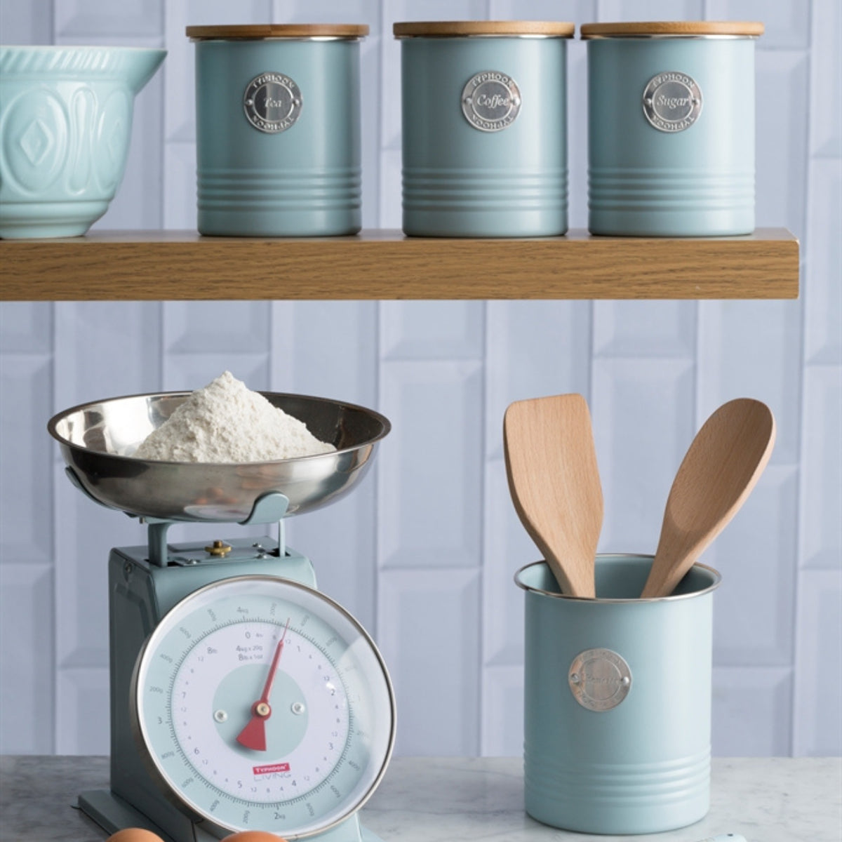 A stylish display of Typhoon Living Sugar Canisters Blue 1 Litre on a shelf, perfect for airtight sugar storage alongside kitchen tools.