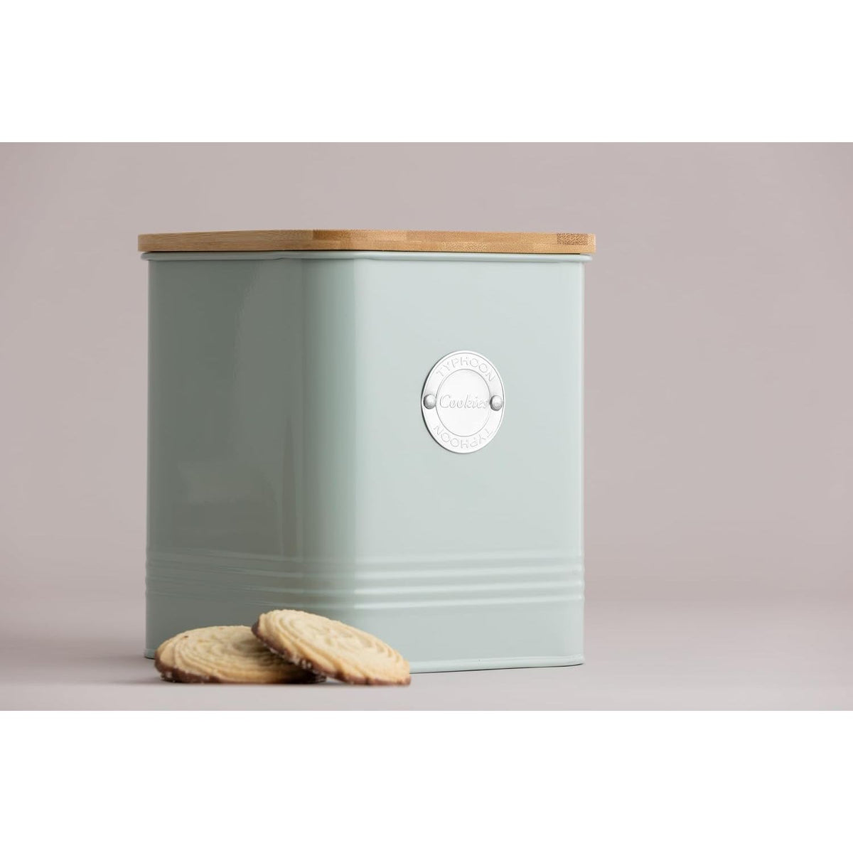 Typhoon Living Squircle Mint Cookie Storage 2.7l canister beside delicious cookies, emphasizing its functionality as an effective cookie storage canister.