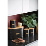 Typhoon Otto Kitchen Storage Canister Set arranged in a kitchen setting with decorative elements, including black metal canisters and a bamboo-lidded bread bin, showcasing perfect kitchen storage.